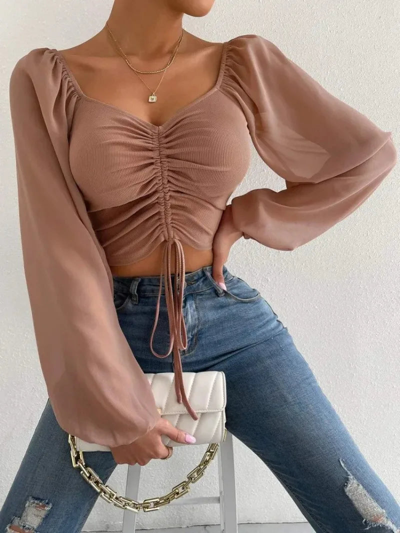 Maglietta donna  Maglietta sexy da donna con maniche a lanterna in rete e coulisse, con petto nudo e ombelico, maniche lunghe
